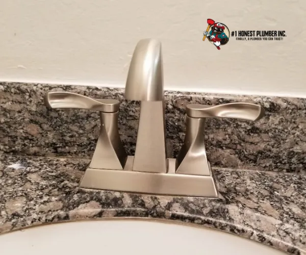 Modern stainless steel undermount kitchen sink with a high-arc chrome faucet and pull-down sprayer.