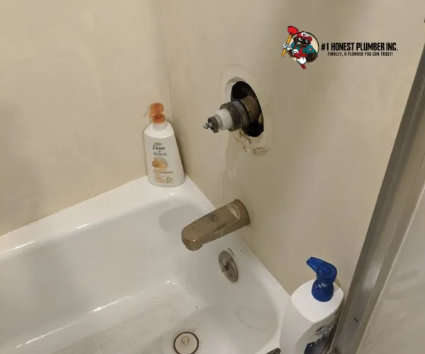 A modern bathroom featuring a white bathtub with a glass walk-in shower enclosure and white subway tile walls.